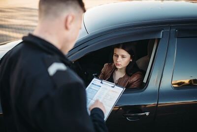 Officer writing reckless driving ticket